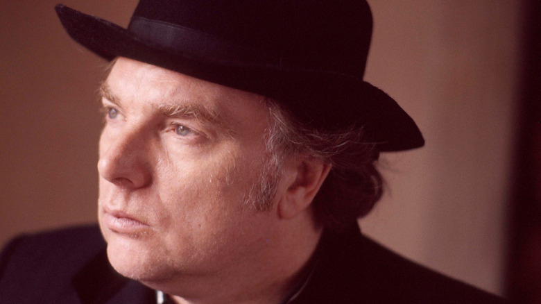Van Morrison in dark suit and hat