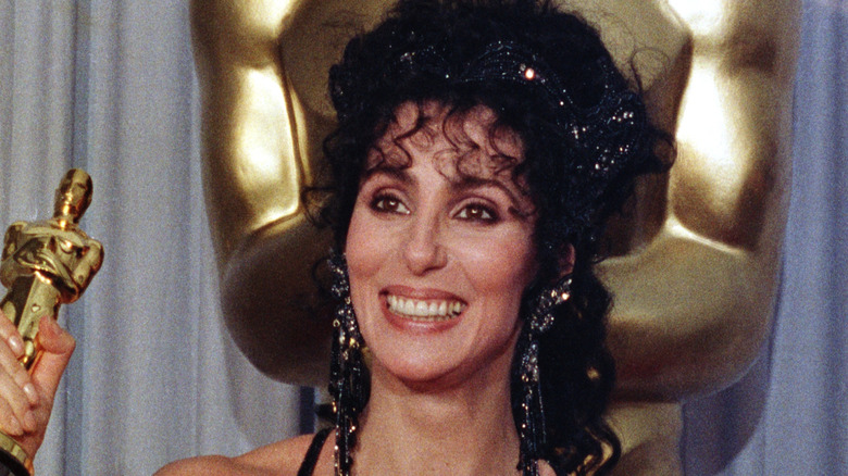 Cher holding her Oscar