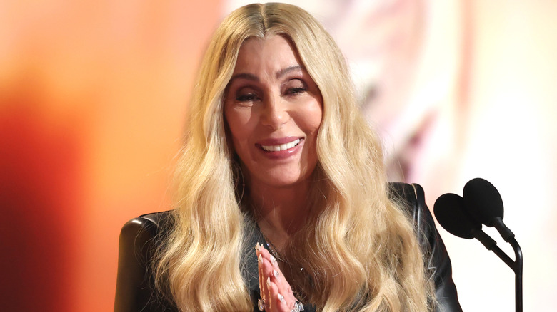 Cher laughing at microphone