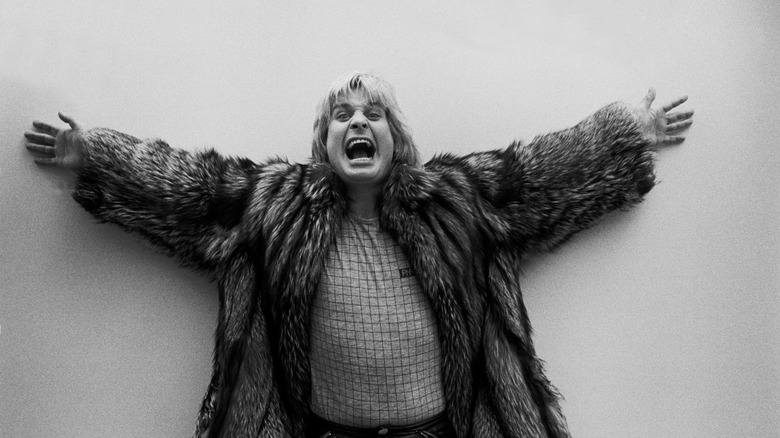 Ozzy Osbourne poses with arms out before concert