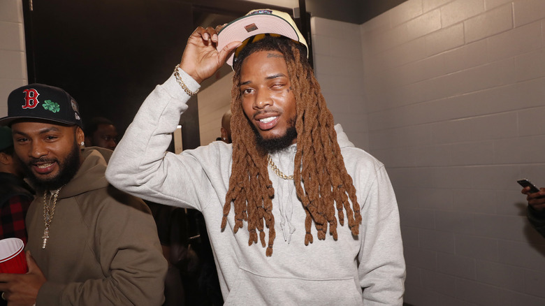 Fett Wap all in white tipping his ballcap