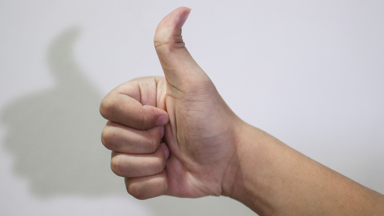 Closeup of thumb bent backwards with shadow