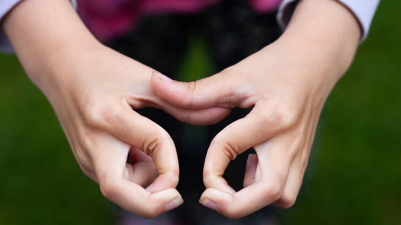 Closeup of hands with hypermobile fingers