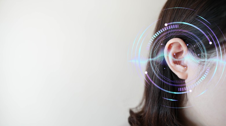 A woman's right ear with stylized sound waves
