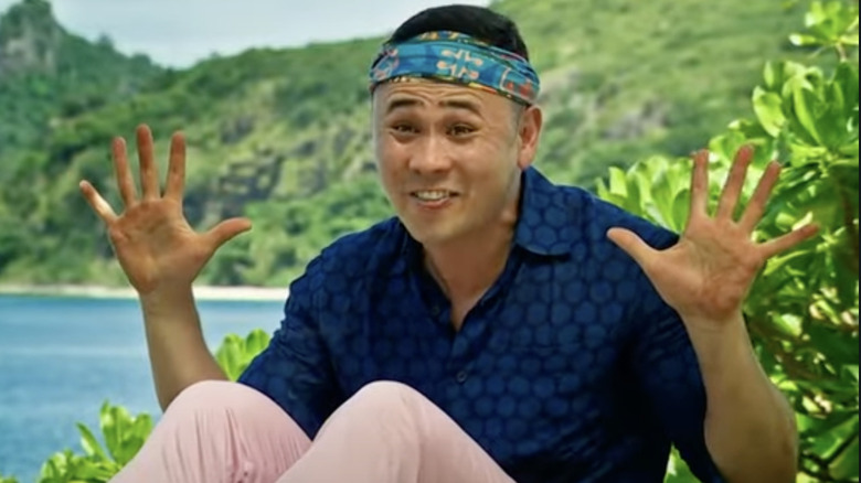 Survivor contestant smiling and holding out palms