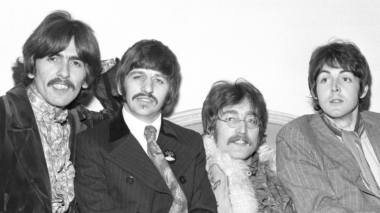 The Beatles sitting on couch