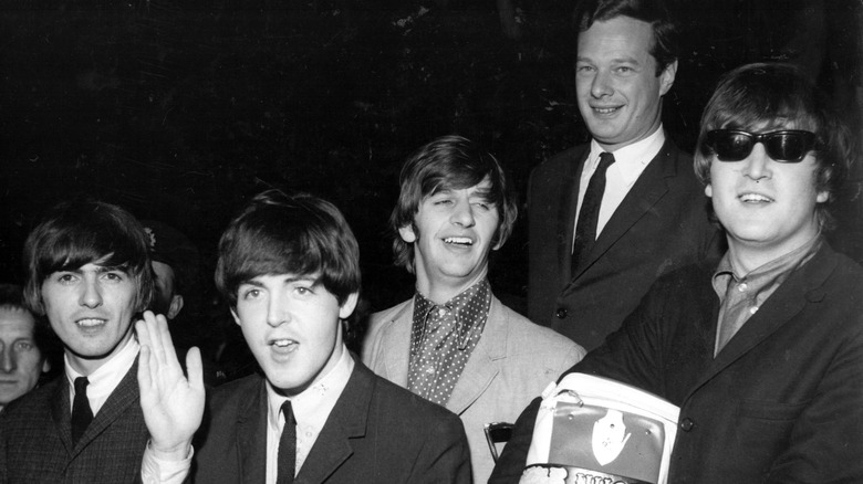 The Beatles and Brian Epstein smiling