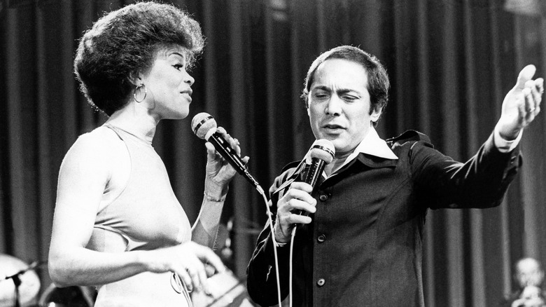 Odia Coates and Paul Anka singing on stage in the 70s