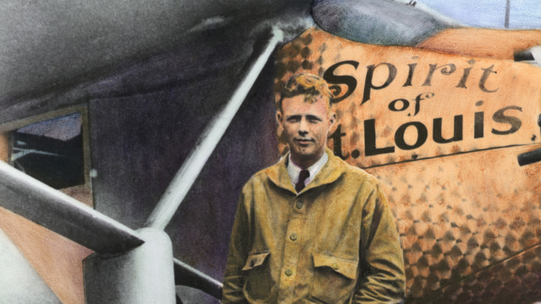 Colorized image of Charles Lindbergh standing in front of Spirit of St. Louis plane