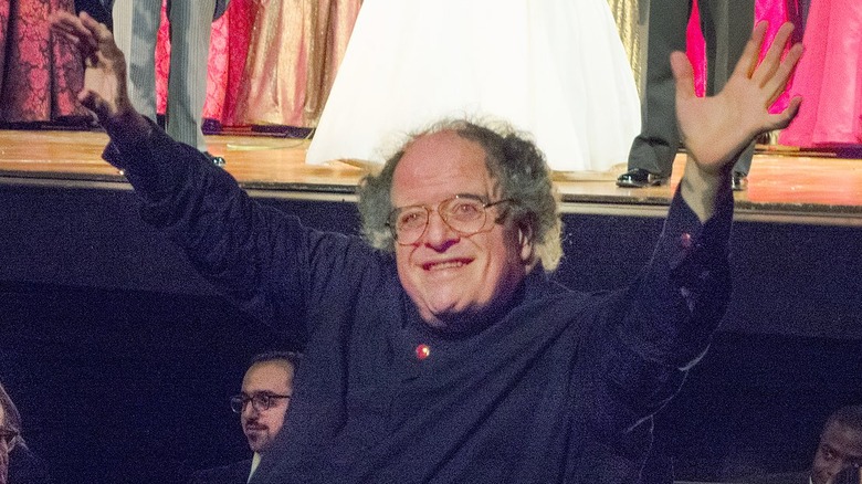 James Levine arms raised blue shirt smiling