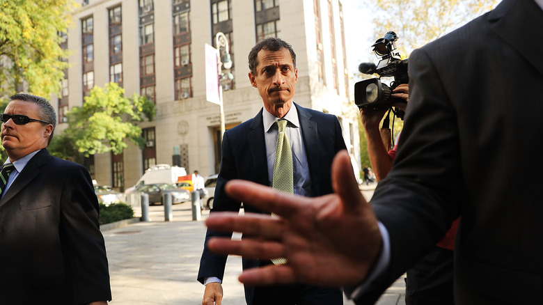 Anthony Weiner and hand trying to block camera