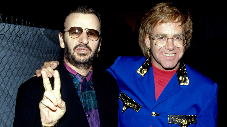 Ringo Starr making peace sign with Elton John smiling