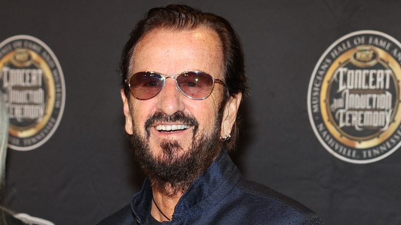 Ringo Starr smiling in sunglasses