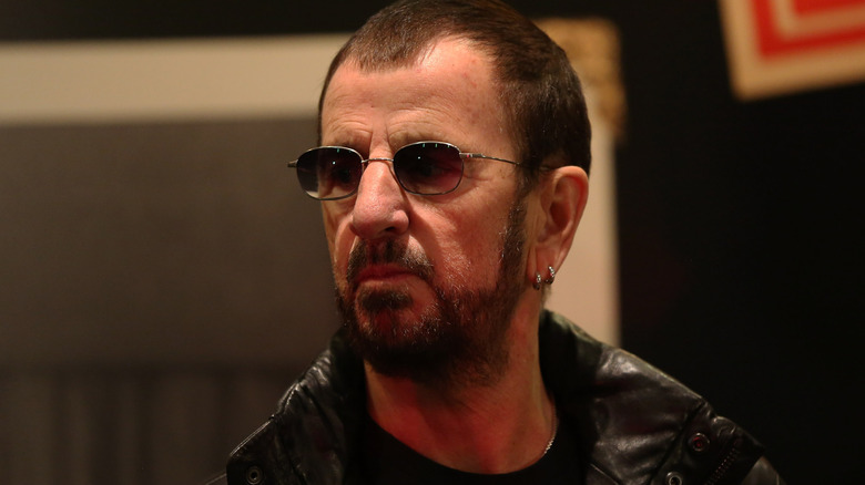 Ringo Starr wearing leather jacket and sunglasses