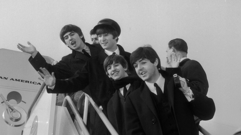 The Beatles leaving a plane
