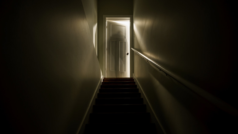 Creepy backlit door at the top of stairs