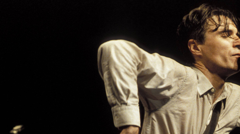 David Byrne flails his arms on stage during the filming of Stop Making Sense