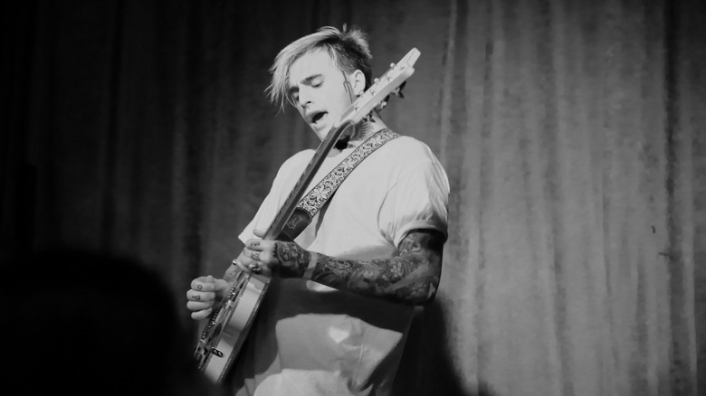 Black and white photo of Johnny Stevens of Highly Suspect playing the guitar during a 2015 gig