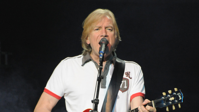 Justin Hayward singing and playing guitar