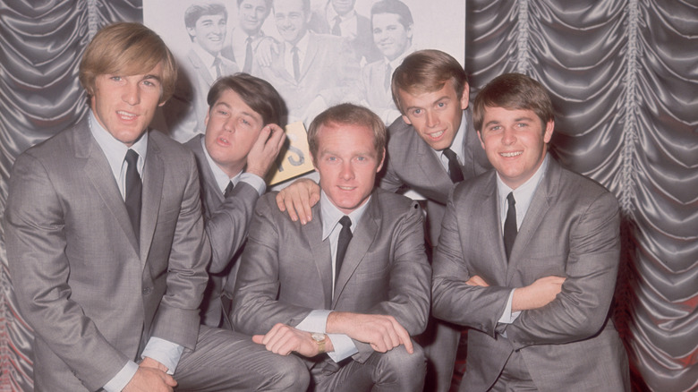 The Beach Boys in suits posing for a photo in 1964.
