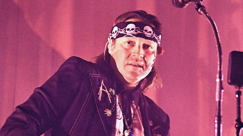 Win Butler in skeleton bandana looking into crowd