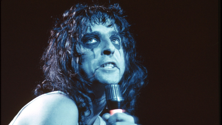 Alice Cooper wearing makeup and performing on stage circa 1970