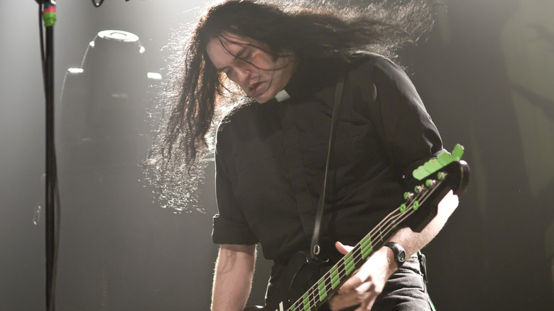 Type O Negative's Peter Steele looking down as he plays bass guitar in 2007