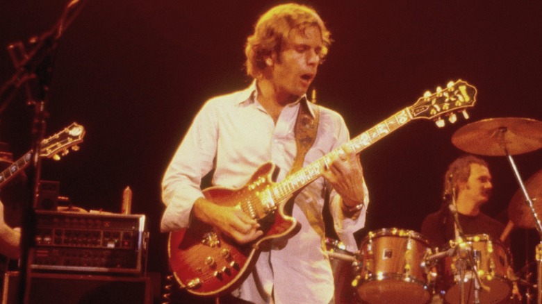 Bob Weir playing guitar onstage