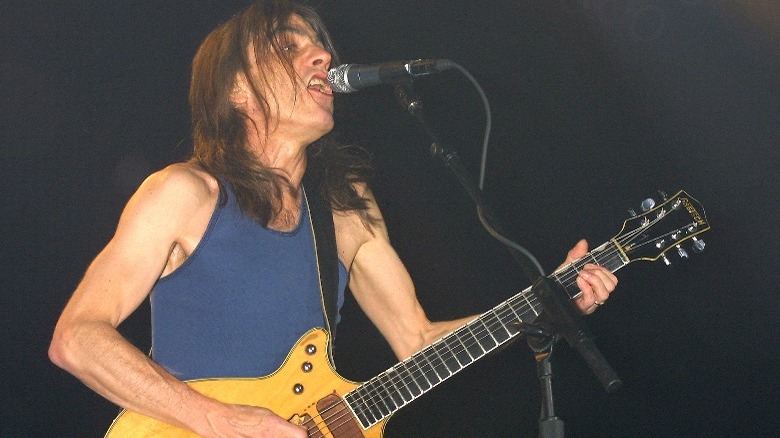 Malcolm Young playing guitar onstage