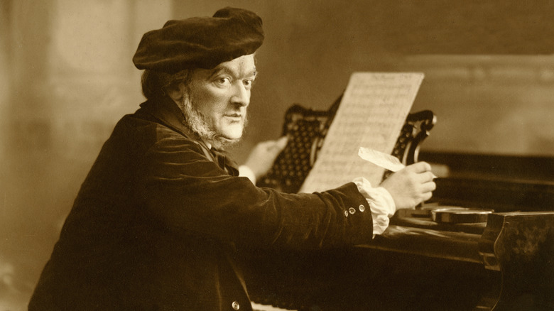 wagner seated at piano and holding quill