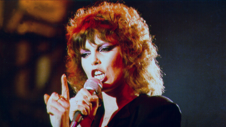 Pat Benatar singing and pointing finger