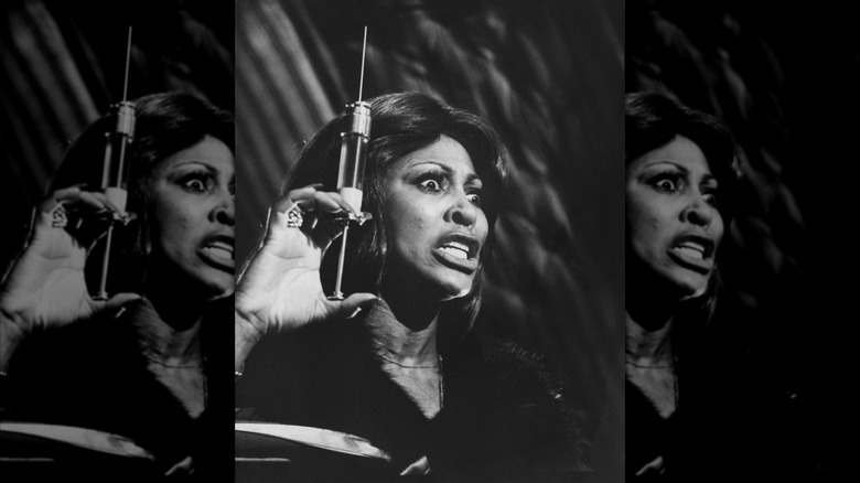 tina turner brandishing a syringe in a still from tommy