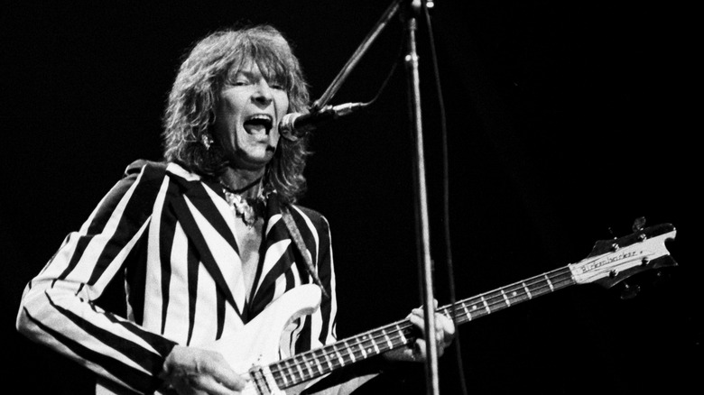 Chris Squire performs with Yes in black and white suit, 1976