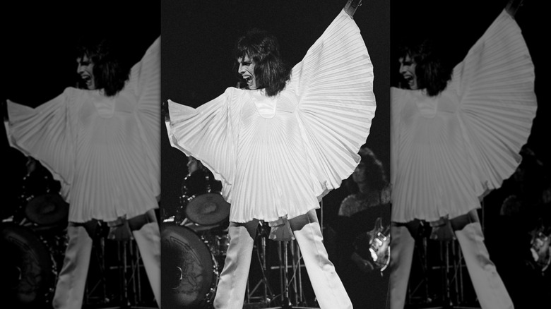 Freddie Mercury performing in white pleated cape, 1974