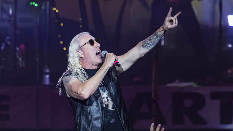 Dee Snider doing metal horns while performing live