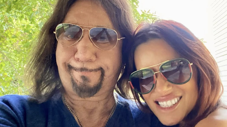 Ace Frehley and Lara Cove smiling in sunglasses