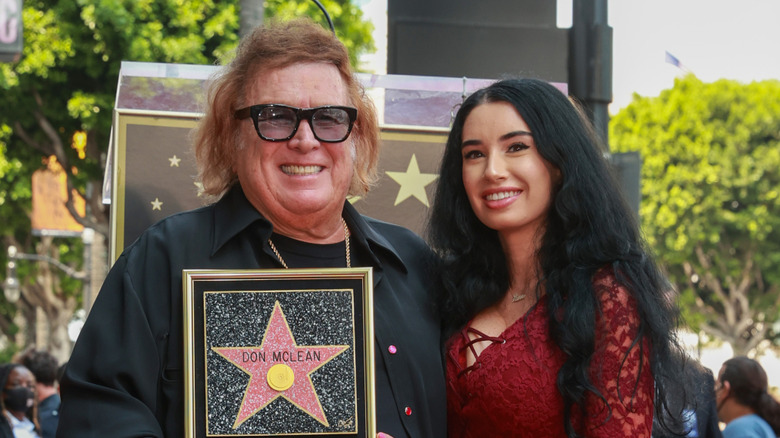 Paris Dylan leans on Don McLean with his Walk of Fame star