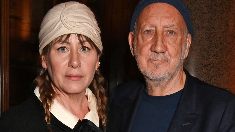 Pete Townshend and Rachel Fuller staring glumly into camera and wearing hats