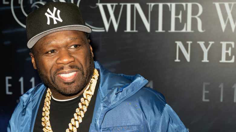 50 Cent posing for the camera at an event.
