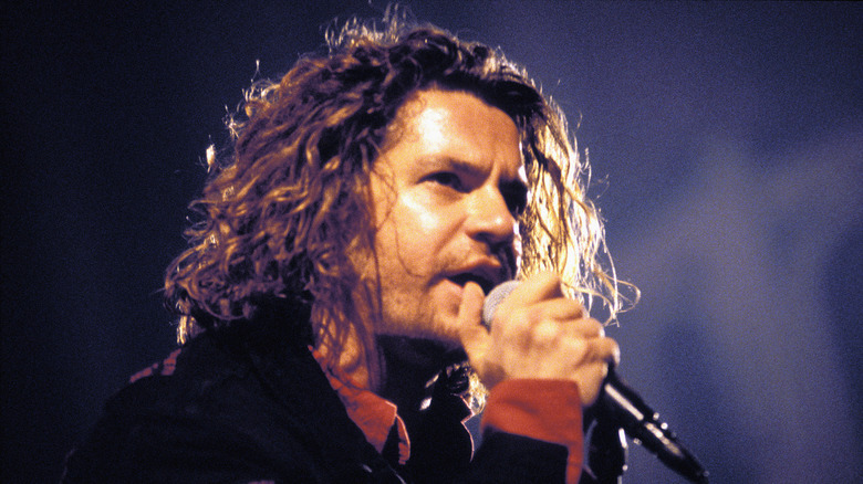Michael Hutchence singing into microphone