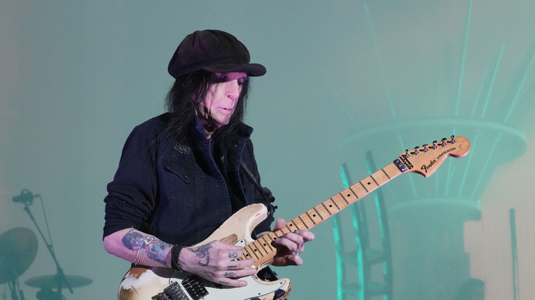 Mick Mars playing guitar onstage