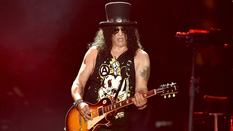Slash onstage playing guitar
