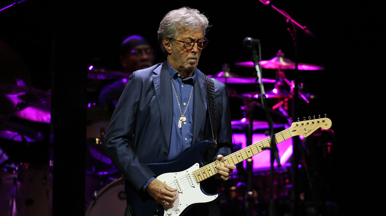 Eric Clapton playing guitar on stage