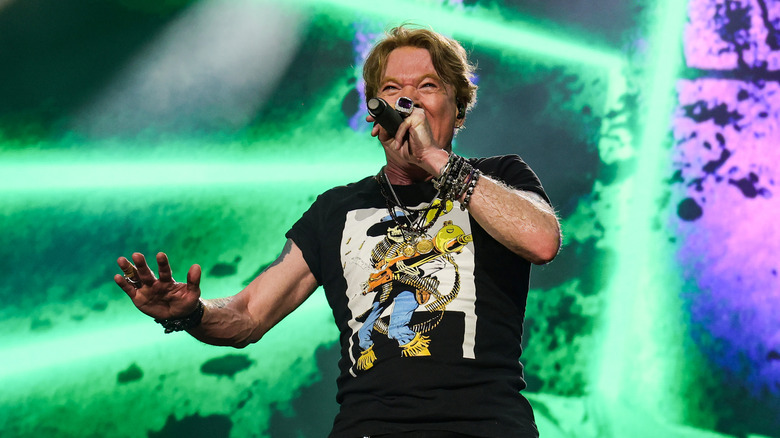Axl Rose performing on stage with Guns N' Roses in 2023