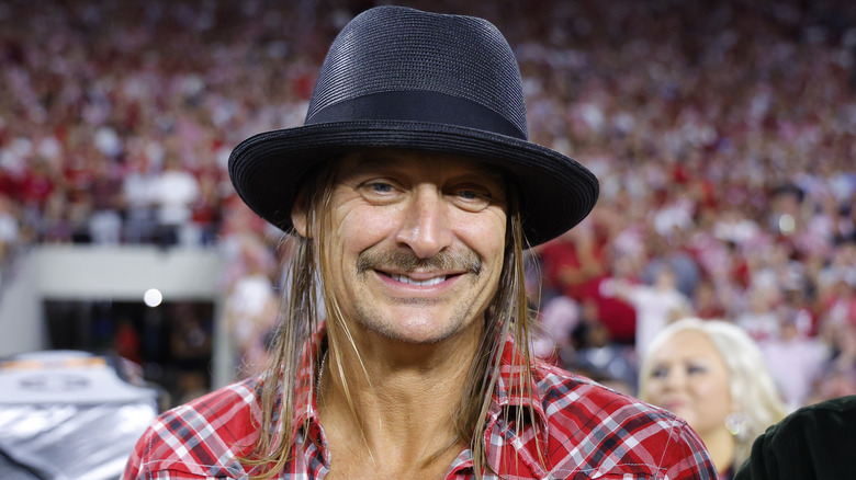 Kid Rock wearing a hat and smiling in 2024