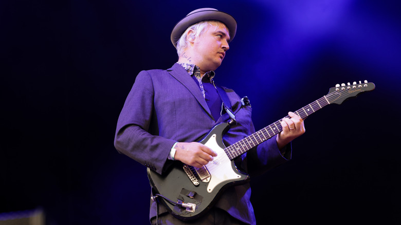 Pete Doherty playing guitar onstage in Sweden