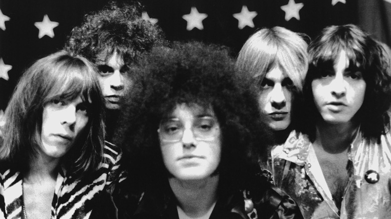 Portrait of MC5 posing in front of an American flag