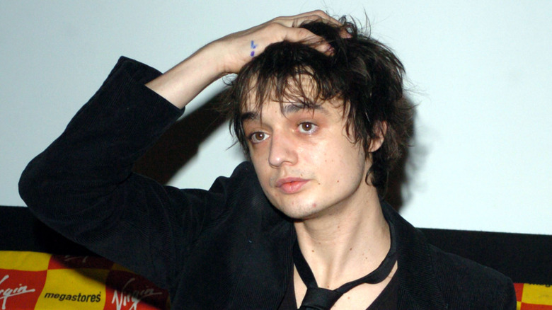 Pete Doherty with his hand on his hair