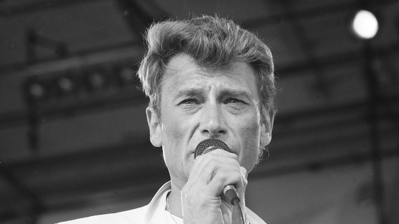 John Hallyday sings into microphone