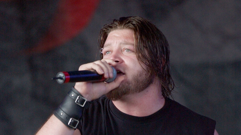 Dave Williams holding a mic and singing on stage